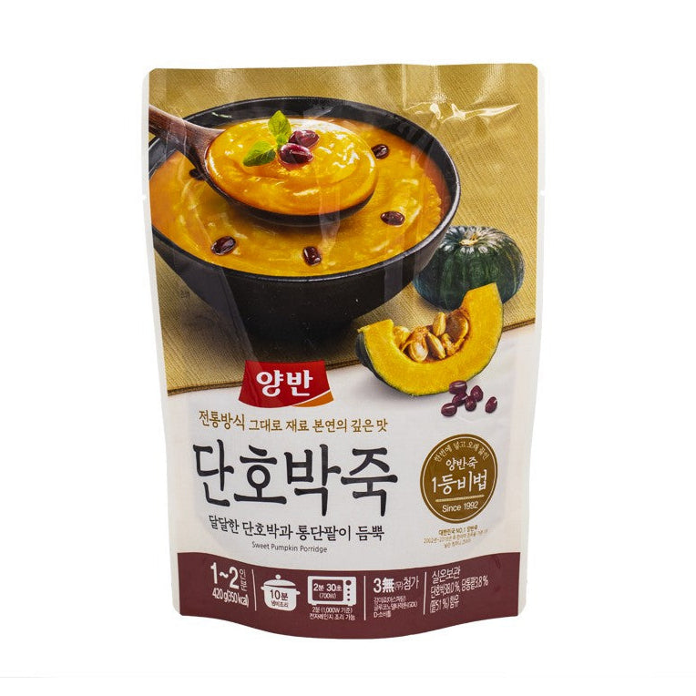 Package of sweet pumpkin porridge with a bowl of porridge and pumpkin on a white background