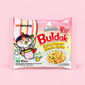 Samyang Buldak Cream Carbonara Ramen 140g light pink packet on a pink background