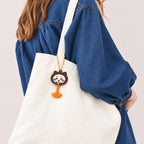 Bandai Chiikawa black cat lolli choco charm attached to a tote bag